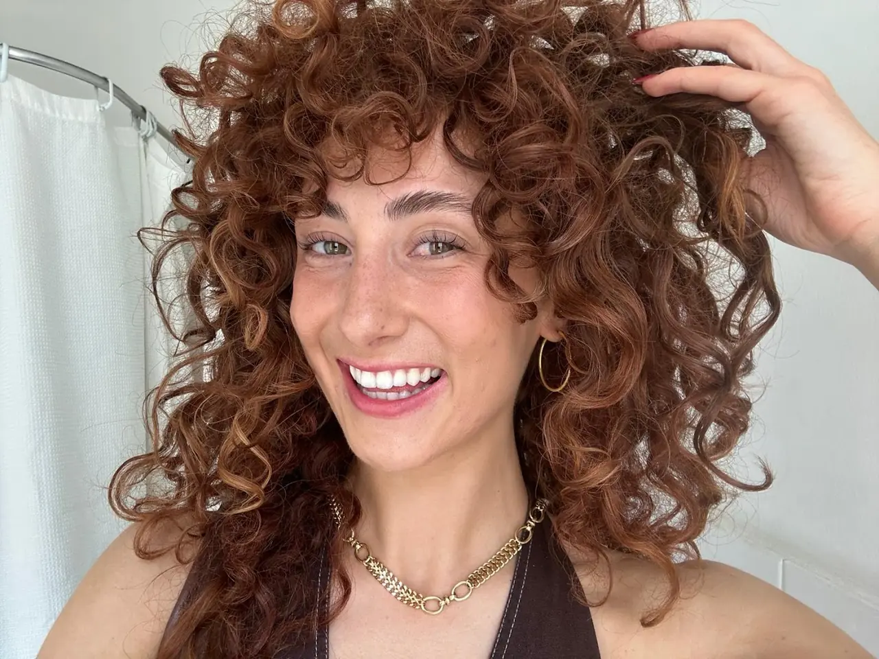 A client smiling with freshly done brows and lashes